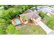 A captivating aerial perspective of a residence featuring a pool and verdant surroundings at 4744 Burlington Rd, Land O Lakes, FL 34639