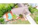 Home with a pool, manicured lawn and garden beds visible from an aerial view at 4744 Burlington Rd, Land O Lakes, FL 34639