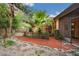 Landscaped backyard featuring a charming fence and healthy palm trees at 4744 Burlington Rd, Land O Lakes, FL 34639