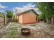 Cozy backyard features a fire pit with colorful filler in a fenced yard at 4744 Burlington Rd, Land O Lakes, FL 34639