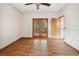 Bedroom with hardwood floors, ceiling fan, and glass paneled doors to the outside at 4744 Burlington Rd, Land O Lakes, FL 34639