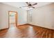 Spacious bedroom with wood floors, ceiling fan and window, view of bathroom with garden tub at 4744 Burlington Rd, Land O Lakes, FL 34639