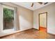 Cozy bedroom featuring wood-look floors, neutral walls, and a ceiling fan at 4744 Burlington Rd, Land O Lakes, FL 34639
