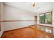 Bright dining room featuring hardwood floors, large windows, and classic trim details at 4744 Burlington Rd, Land O Lakes, FL 34639