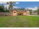 Charming single-Gathering home with a well-manicured lawn, mature landscaping, and a beautiful palm tree at 4744 Burlington Rd, Land O Lakes, FL 34639