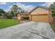 Home with a well-maintained lawn, desert landscaping, and a paved driveway leading to a two-car garage at 4744 Burlington Rd, Land O Lakes, FL 34639
