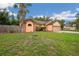 Charming single-Gathering home with a well-manicured lawn, mature landscaping, and a beautiful palm tree at 4744 Burlington Rd, Land O Lakes, FL 34639