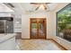 Eat-in kitchen featuring tiled floors and glass paneled doors leading to the backyard at 4744 Burlington Rd, Land O Lakes, FL 34639