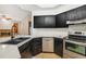 Modern kitchen featuring black cabinets, stainless steel appliances, and ample counter space at 4744 Burlington Rd, Land O Lakes, FL 34639