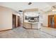 Bright kitchen with stainless steel appliances and white marble countertops open to the living area at 4744 Burlington Rd, Land O Lakes, FL 34639