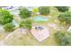Aerial shot of a community playground featuring a variety of equipment, set in a spacious and green area at 4744 Burlington Rd, Land O Lakes, FL 34639