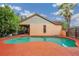 Backyard pool featuring a unique design and orange patio at 4744 Burlington Rd, Land O Lakes, FL 34639