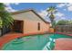 Backyard pool with a sun shelf, next to a screened patio at 4744 Burlington Rd, Land O Lakes, FL 34639