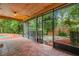 View of tiled porch with screen to the pool and side yard at 4744 Burlington Rd, Land O Lakes, FL 34639