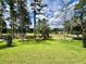 Lush green backyard view overlooking a golf course and mature trees at 4773 Hickory Oak Dr, Brooksville, FL 34601