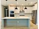 Modern kitchen featuring white cabinets, stainless steel appliances, and a large island at 4773 Hickory Oak Dr, Brooksville, FL 34601