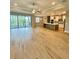 Spacious living room with open floor plan, wood floors, and natural light at 4773 Hickory Oak Dr, Brooksville, FL 34601