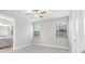 Carpeted bedroom with two windows, neutral paint, and an attached bathroom at 4799 Hickory Oak Loop, Brooksville, FL 34601