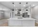 Modern kitchen with an island, stainless steel appliances, pendant lights, and a marble backsplash at 4799 Hickory Oak Loop, Brooksville, FL 34601