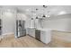 Modern kitchen with stainless steel appliances, an island with a quartz countertop, and a ceiling fan at 4799 Hickory Oak Loop, Brooksville, FL 34601