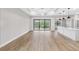 Bright open concept living room featuring hardwood floors, ceiling fan, sliding doors, and an island with pendant lights at 4799 Hickory Oak Loop, Brooksville, FL 34601