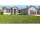 Well-maintained single-story house features a lush green lawn and a contemporary exterior at 5104 Munhal St, Port Charlotte, FL 33981