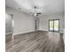 Bright living room with LVP flooring and sliding glass doors that provide natural light at 5104 Munhal St, Port Charlotte, FL 33981