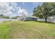 Expansive backyard with well-maintained lawn, white fence, and storage shed, perfect for outdoor activities at 5334 Tummel Ct, Wesley Chapel, FL 33545