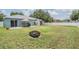 Large backyard with patio, grill, swing, fire pit, and white fence for outdoor enjoyment at 5334 Tummel Ct, Wesley Chapel, FL 33545