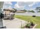 A spacious backyard with a patio area, outdoor seating, and well-maintained lawn at 5334 Tummel Ct, Wesley Chapel, FL 33545