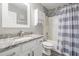 Well-lit bathroom featuring a white vanity with granite countertop and a shower with decorative tile accents at 5334 Tummel Ct, Wesley Chapel, FL 33545