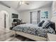 Bedroom boasts a bed with blue patterned sheets and a TV with computer setup at 5334 Tummel Ct, Wesley Chapel, FL 33545