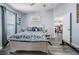 Comfortable bedroom with soft grey walls, wood-look floors, and tasteful decor with easy access to a well-equipped kitchen at 5334 Tummel Ct, Wesley Chapel, FL 33545