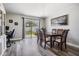 Bright dining room with wood floors, dining table and chairs, with sliding doors to the backyard at 5334 Tummel Ct, Wesley Chapel, FL 33545