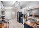 Open kitchen with white cabinets, wood counters, stainless appliances, and modern lighting at 5334 Tummel Ct, Wesley Chapel, FL 33545