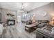 Spacious living room with vaulted ceiling, gray walls, and wood look flooring at 5334 Tummel Ct, Wesley Chapel, FL 33545