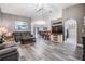 Open concept living room with wood look flooring, modern lighting, and comfortable seating at 5334 Tummel Ct, Wesley Chapel, FL 33545