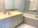 Bathroom features a double vanity, soaking tub and a tiled backsplash at 5530 Salem Square N Dr, Palm Harbor, FL 34685