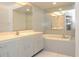 Bathroom with tile floor, soaking tub, large mirror, and vanity with ample storage at 5530 Salem Square N Dr, Palm Harbor, FL 34685