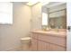 Bathroom featuring tile floors, toilet, vanity, and mirror at 5530 Salem Square N Dr, Palm Harbor, FL 34685