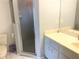 Bathroom includes a shower, toilet, and vanity with a mirror; floral decoration on shower door at 5530 Salem Square N Dr, Palm Harbor, FL 34685