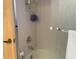 Simple bathtub and shower with tiled walls and a glass door at 5530 Salem Square N Dr, Palm Harbor, FL 34685