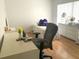 Bright bedroom with hardwood floors and a dedicated desk space at 5530 Salem Square N Dr, Palm Harbor, FL 34685