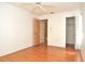Bright bedroom with hardwood floors, ceiling fan, and access to closet and additional room at 5530 Salem Square N Dr, Palm Harbor, FL 34685