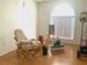 Bedroom featuring wood floors and lots of light from a large window at 5530 Salem Square N Dr, Palm Harbor, FL 34685