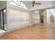 Bright bedroom features a ceiling fan, mirror closet, and sliding glass doors at 5530 Salem Square N Dr, Palm Harbor, FL 34685