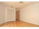 Bedroom with closet, laminate flooring, and view of an open doorway at 5530 Salem Square N Dr, Palm Harbor, FL 34685