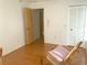 Bright bedroom featuring wood floors, a rocking chair, and a closet at 5530 Salem Square N Dr, Palm Harbor, FL 34685