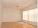Bedroom with laminate flooring, ceiling fan, and window with vertical blinds at 5530 Salem Square N Dr, Palm Harbor, FL 34685