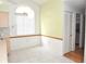 Bright dining area with tiled flooring, large window, and doorway to a bathroom at 5530 Salem Square N Dr, Palm Harbor, FL 34685